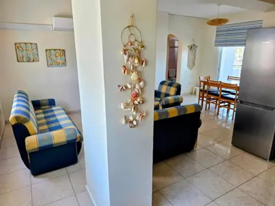 a living room with couches and a christmas tree at Niki's Coastal Escape in Larnaka