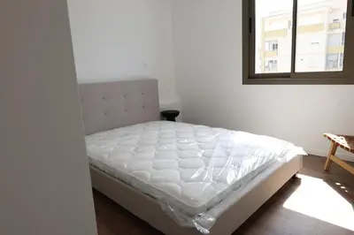 a white bed in a room with a window at Alaya Residence in Nicosia