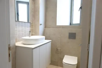 a bathroom with a sink and a toilet at Alaya Residence in Nicosia