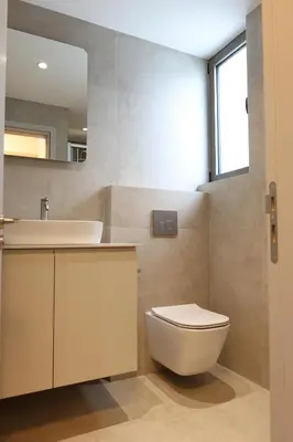 a bathroom with a toilet and a sink and a mirror at Alaya Residence in Nicosia