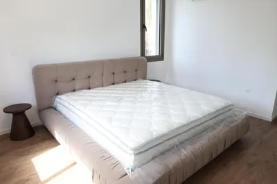 a bed in a room with a white mattress at Alaya Residence in Nicosia