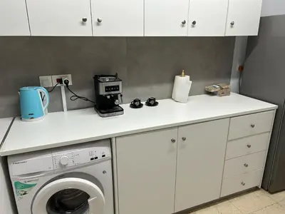 a kitchen with a washing machine and a counter at The relaxing apartment in Paralimni