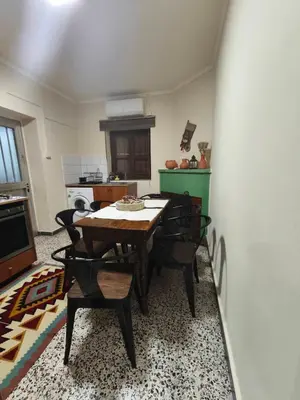 a kitchen with a table and chairs in a room at Casa del Kampos in Kambos
