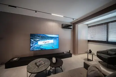 a living room with a couch and a flat screen tv at Dest Retreat Beach & City Apt in Limassol