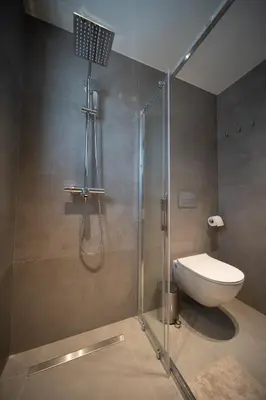 a bathroom with a shower with a toilet and a sink at Dest Retreat Beach & City Apt in Limassol