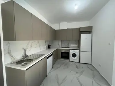 a white kitchen with a sink and a dishwasher at Larnaca Elysium Seaside & Pool Retreat in Livadhia
