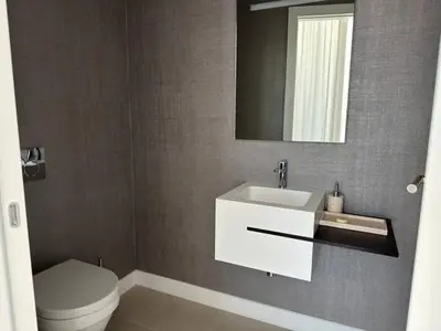 a bathroom with a sink and a toilet and a mirror at Ayia-Napa Marina Luxury Appartments in Ayia Napa