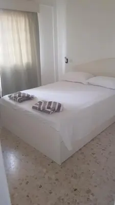 a large white bed with two pillows on it at Nice Room in Limassol center in Limassol