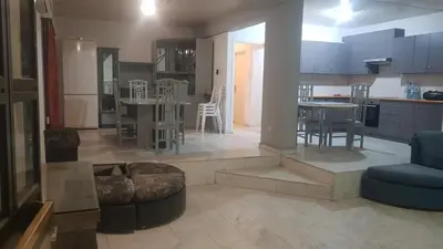 a kitchen and living room with a table and chairs at Nice Room in Limassol center in Limassol