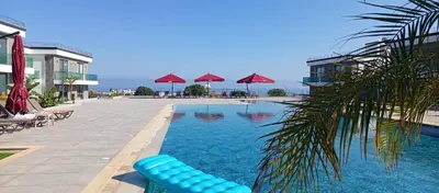a swimming pool with a blue raft in a resort at Sunprime Premium Site in Pyla