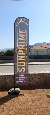 a sign sitting on the side of a road at Sunprime Premium Site in Pyla