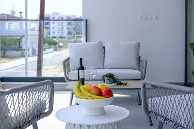 a bowl of fruit on a table with a bottle of wine at Artemis 102 - Seaside Stories in Livadhia
