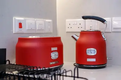 two red toasters sitting on a kitchen counter at Artemis 102 - Seaside Stories in Livadhia