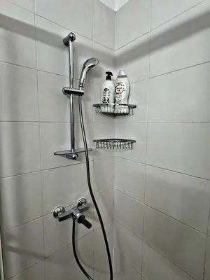 a bathroom with a shower with a shower head at Charm Flat in the heart of the City Center - Balcony & view in Nicosia
