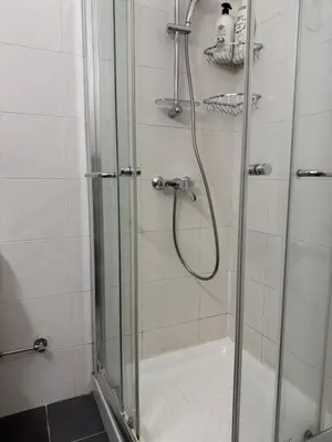 a bathroom with a shower with a glass door at Charm Flat in the heart of the City Center - Balcony & view in Nicosia