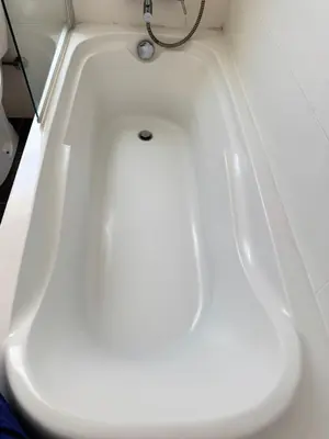 a white bath tub with a silver drain at Charm Flat in the heart of the City Center - Balcony & view in Nicosia
