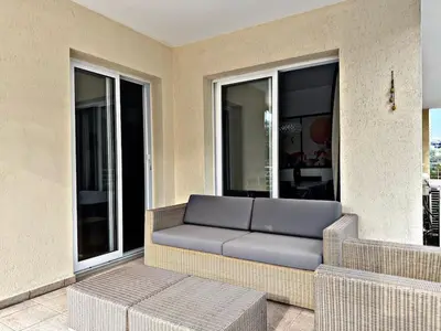 a couch sitting on a balcony with windows at Charm Flat in the heart of the City Center - Balcony & view in Nicosia