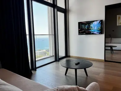 a living room with a table and large windows at STAY ONLY Tower Suites in Limassol