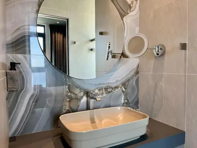 a bathroom with a sink and a mirror at STAY ONLY Tower Suites in Limassol