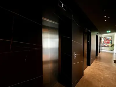 a hallway with black walls and a metal elevator at STAY ONLY Tower Suites in Limassol