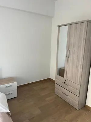 a bedroom with a dresser and a large mirror at El Giorgios City Centre Apartment in Larnaka