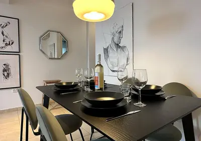 a dining room table with glasses and a bottle of wine at The Seven - One Bedroom Apartment in Paralimni