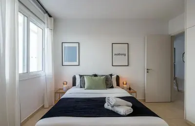 a bedroom with a large bed with two pillows on it at The Seven - One Bedroom Apartment in Paralimni
