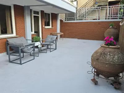 a patio with chairs and a vase with flowers in it at Maryland Lodge hideaway in Kakopetria