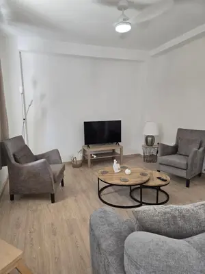 a living room with couches and a table and a tv at Maryland Lodge hideaway in Kakopetria