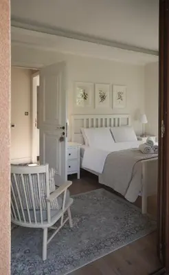 a bedroom with a bed and a chair and a desk at Stou Savvide - Pera Pedi Stone Manor in Perapedhi
