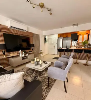 a living room with a couch and a table at Atalanta rooms in Larnaka