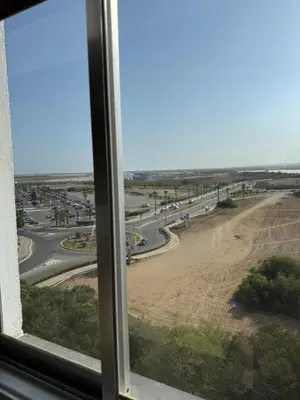 a view of a road from a window at Atalanta rooms in Larnaka