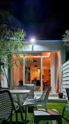 a table and chairs on a patio at night at Protaras Ayios Elias Maisonette in Protaras