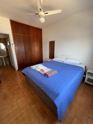 a bedroom with a bed with blue sheets and a ceiling at Zygi Beachfront Retreat! in Zygi