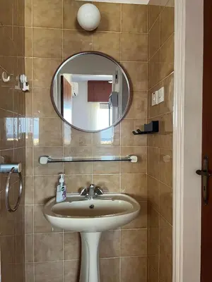 a bathroom with a sink and a mirror at Zygi Beachfront Retreat! in Zygi