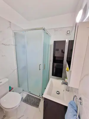 a bathroom with a shower and a toilet and a sink at Quiet Top Floor One Bedroom Apartment in Pyla Near Beach in Voroklini