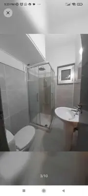 a bathroom with a shower and a toilet and a sink at Однокомнатная квартира на берегу моря in Zygi