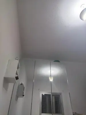 a white room with a mirror and a ceiling at Однокомнатная квартира на берегу моря in Zygi