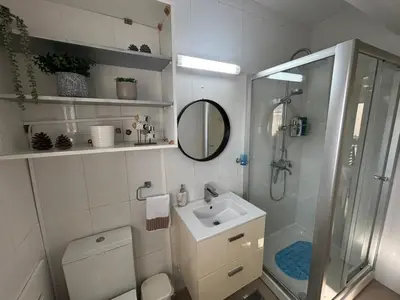 a bathroom with a toilet and a sink and a shower at Modern 2BR Apartment 70m from Finikoudes beach in Larnaka