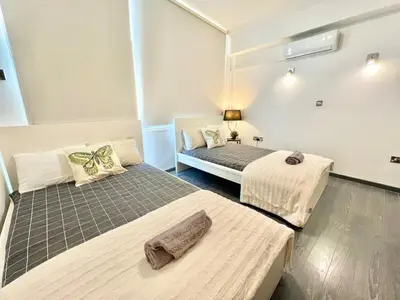 a room with two beds in a room at Millenia Apartment in Nicosia