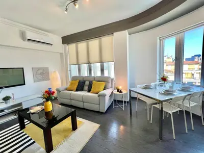 a living room with a table and a couch and a dining room at Millenia Apartment in Nicosia