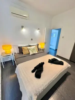 a bedroom with two beds with black gloves on them at Millenia Apartment in Nicosia