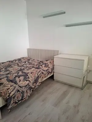 a bedroom with a bed and a dresser at Comfortable Ground Floor Studio in Limassol in Limassol
