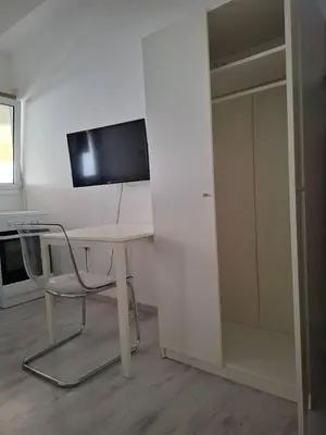a white desk with a chair and a television at Comfortable Ground Floor Studio in Limassol in Limassol
