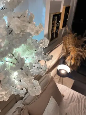 a tree with white flowers on it in a room at Boho Studio mit Meerblick in Boğaz