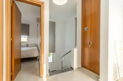 a hallway with a door leading to a bedroom at Black Swan Villa in Pervolia
