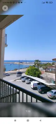 a view of a parking lot with cars parked at A separate room with a shared bathroom and 50 meters from the sea in Zygi