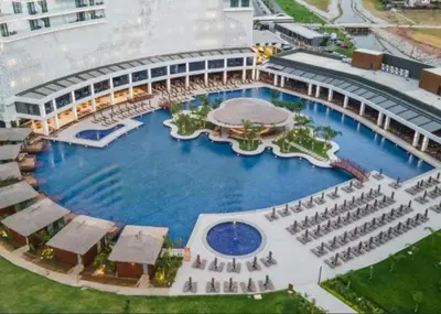 an overhead view of a large pool in a building at 2Bedroom Apartment in Grand Sapphire Complex Featuring a Pool and Casino in Lemithou