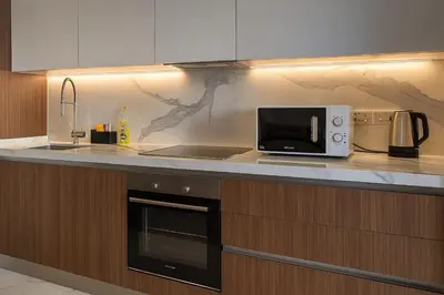 a kitchen with a microwave and a counter top at 2Bedroom Apartment in Grand Sapphire Complex Featuring a Pool and Casino in Lemithou