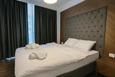 a bedroom with a large bed with two towels on it at 2Bedroom Apartment in Grand Sapphire Complex Featuring a Pool and Casino in Lemithou
